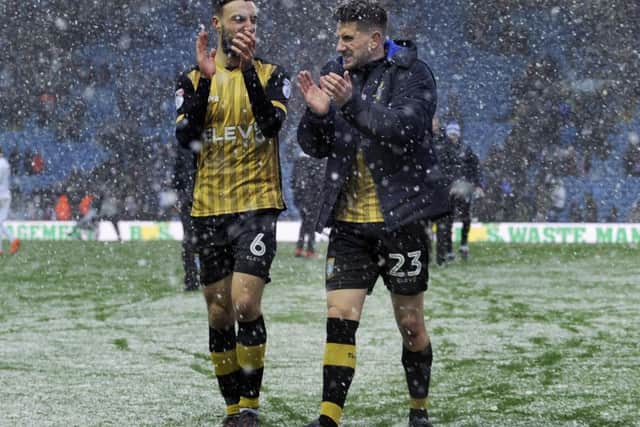The Owls pair of Morgan Fox and Sam Hutchinson celebrating victory in the snow at Elland Road....Pic Steve Ellis