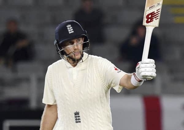 England's Joe Root signals his 50 against New Zealand during their first cricket test in Auckland, New Zealand