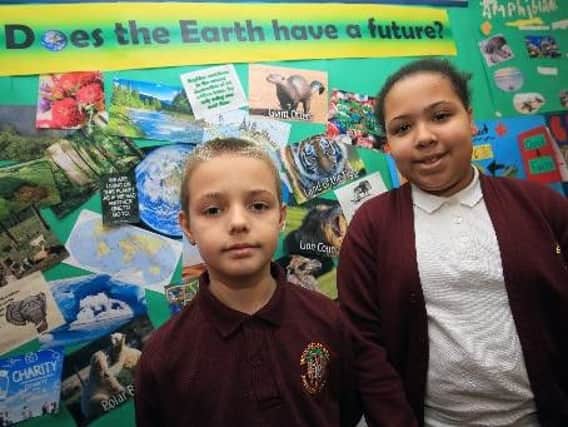 Year 6 pupils Kain Hague, ten, and Shirley Bassey, 11, with their earth project display