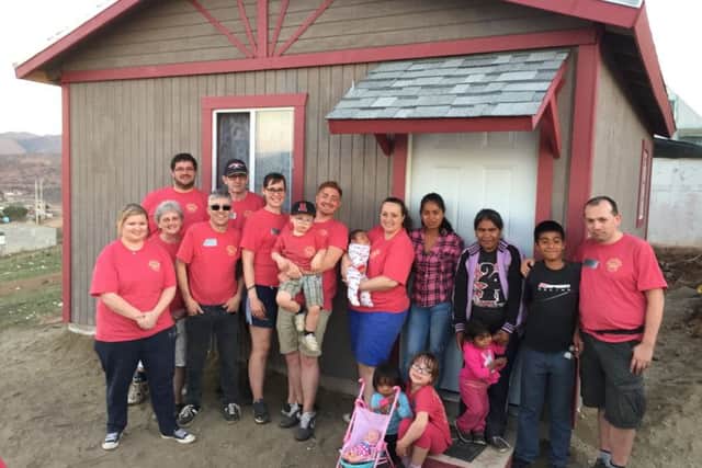 The team of volunteers with the completed house