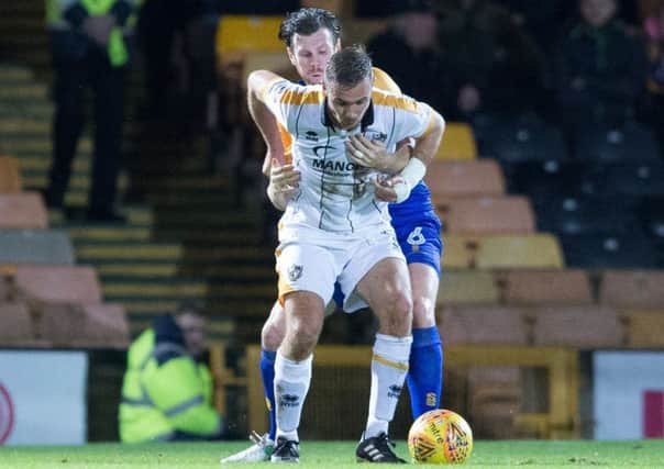 Port Vale vs Mansfield Town - Zander Diamond of Mansfield Town defending against Tom Pope of Port Vale - Pic By James Williamson