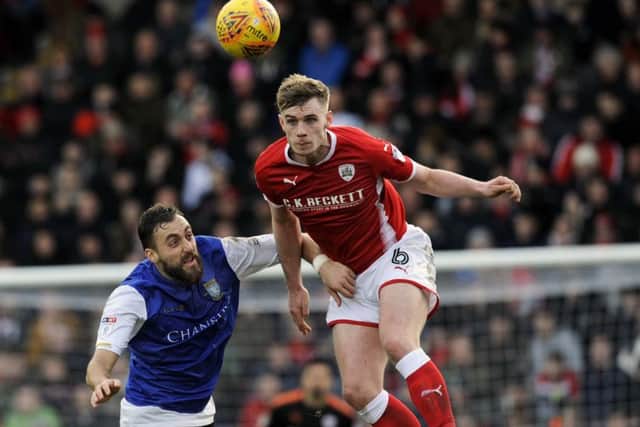 Reds Liam Lindsay beats Owls Atdhe Nuhiu.....Pic Steve Ellis