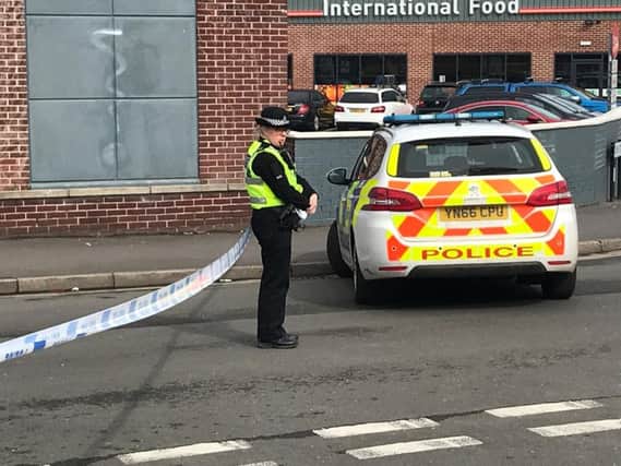 An officer at the cordon on Hill Street. Picture: George Torr/The Star