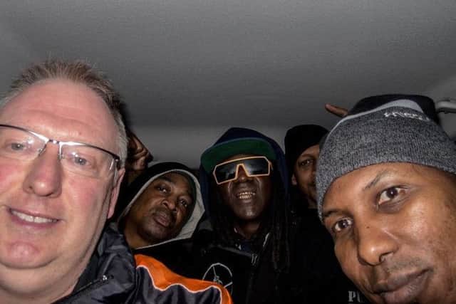 The real-life selfie from 2015, with Kevin Wells, left, and Public Enemy.