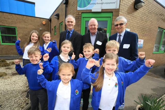 Current headteacher Paul Stockley, past deputy headteacher Rob Poole and past headteacher Bob Driskell with pupils