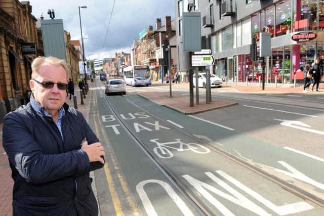 Businessman Steve Wilkinson beside a controversial bus gate on Glossop Road in Sheffield city centre