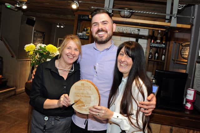 Rebecca Aitken, right, the manager of The Fox House, with Thelma Langton and assistant manager, Jamie Woodgate and the award for Country Pub of the Year from Countryfile Magazine.