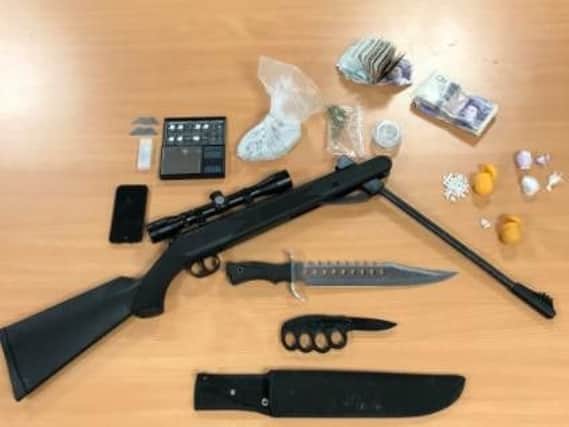 A firearm, knives, drugs and cash were found during a police raid in Rotherham