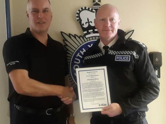 PC Dave Shaw (left) receives his certificate from Chief Supt Stuart Barton. Picture: Sheffield Central NHP.