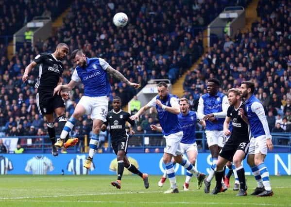 Fulham's Dennis Odoi (left) and Sheffield Wednesday's Daniel Pudil battle for the ball in the air during the Sky Bet Championship match at Hillsborough, Sheffield. PRESS ASSOCIATION Photo.