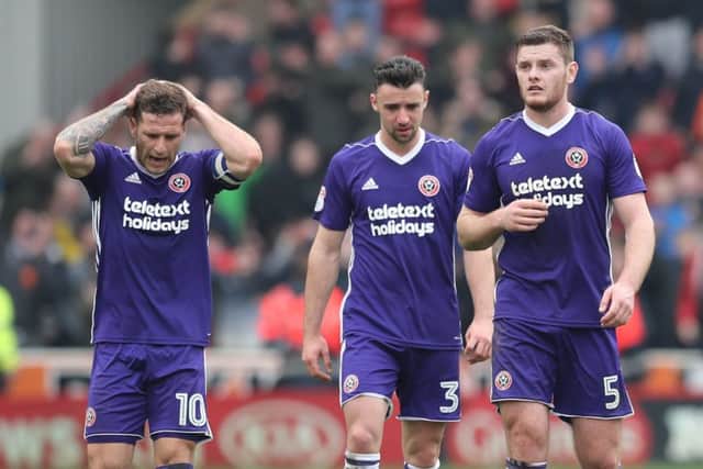 Deflated: Billy Sharp, Enda Stevens and Jack O'Connell feel the pain of the Blades defeat at Oakwell. Picture: Simon Bellis/Sportimage