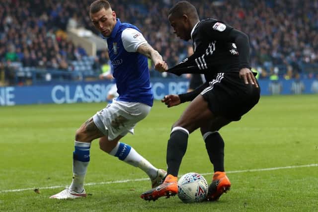 Fulham's Ryan Sessegnon (right) and Sheffield Wednesday's Jack Hunt battle for the ball during the Sky Bet Championship match at Hillsborough, Sheffield. PRESS ASSOCIATION Photo.