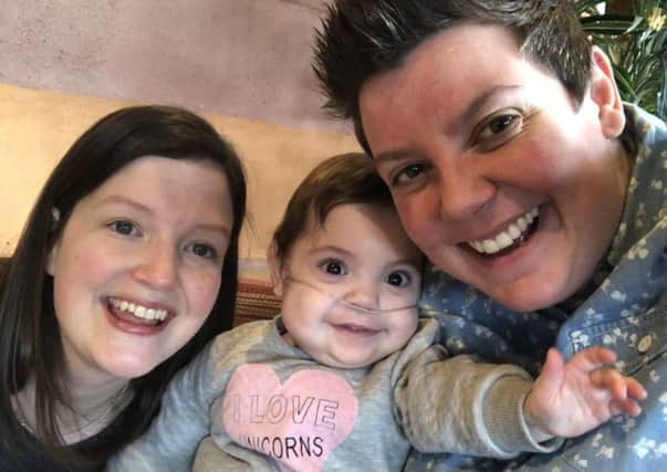 Claire Crane (left) and her fiancÃ©e Michelle Hawley (right), both of Sheffield, with their baby Megan. The mums have decided to enter the Sheffield Hospital Charity Jessops Superheroes event to thank doctors and nurses for their care of Megan after she was born at 27 weeks.