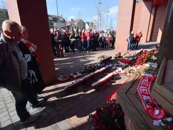 Fans pay their respects at the Hillsborough memorial as they arrived at Anfield ahead of the Premier League match at Anfield. Devlin/PA Wire.