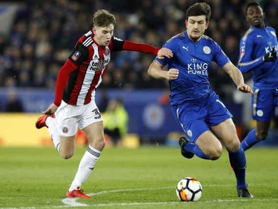 Harry Maguire (right) in action for Leicester City against old club Sheffield United earlier this season