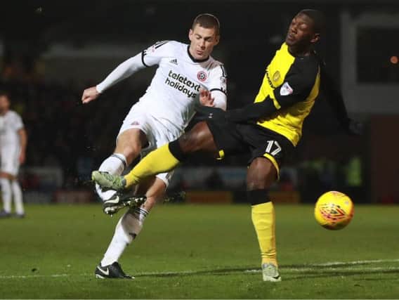 Paul Coutts is challenged by Marvin Sordell