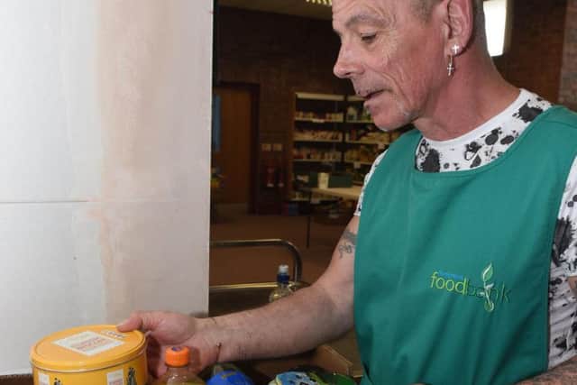 Russell Hawker of Burngreave Foodbank searches through the donated food.