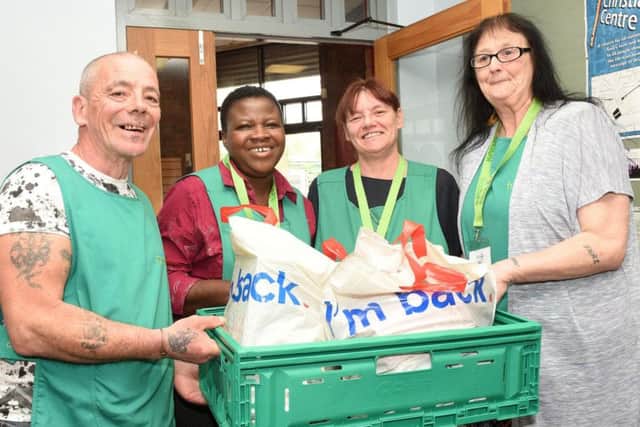 Russell Hawker, Clara Oni, Lisa Dernie and Nikki Lacey of Burngreave Foodbank with a food parcel.