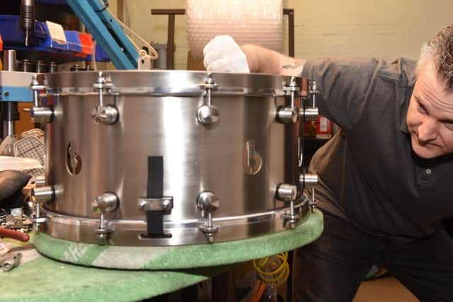 Alan van Kleef, of VK Drums inspects one of his products.