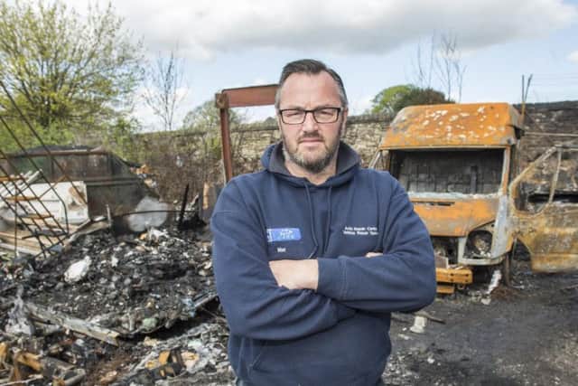 Owner Matt Hunt with the damaged cars and vans set alight by vandals at Auto Repair Centre in Darnall.