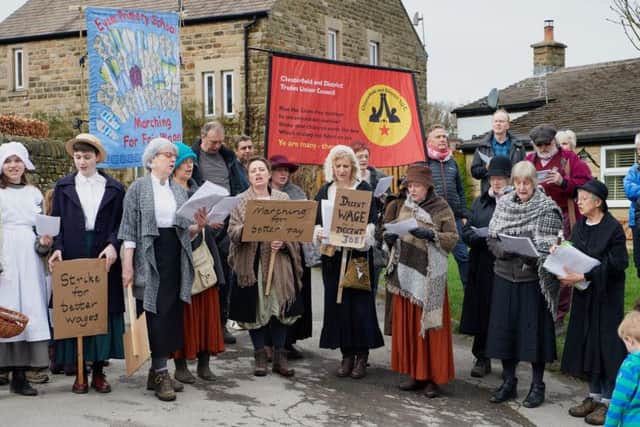Modern union banners join the re-enactors marking the centenary of as boot and shoe-makers' strike in Eyam and Stoney Middleton