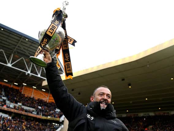 Wolverhampton Wanderers manager Nuno Espirito Santo celebrates with the trophy after the Sky Bet Championship match at Molineux, Wolverhampton. PRESS ASSOCIATION Photo.