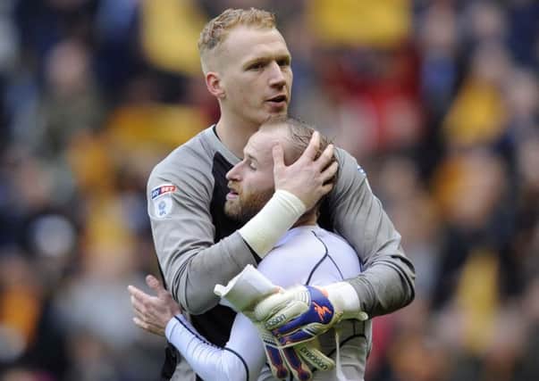 Owls keeper Cameron Dawson and Barry Bannan embrace at the final whistle....Pic Steve Ellis