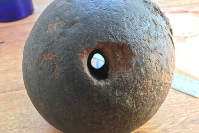 The suspected cannonball up close - it is claimed the hole punched through the centre gives it away as a weight from a fly press.