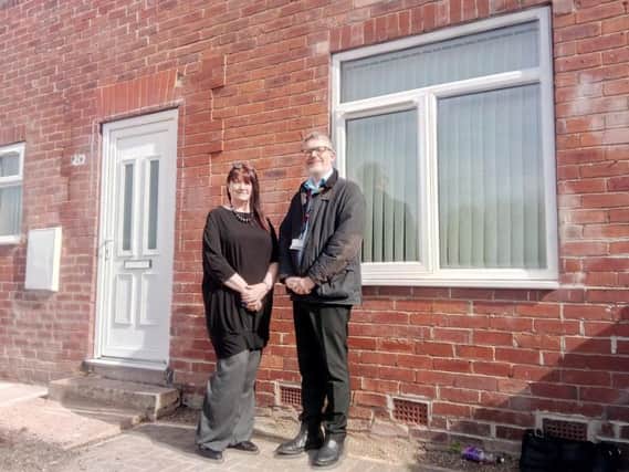 Transformed: Barnsley Community Build's Sue Shaw and Barnsley Council housing officer David Malsom outside a restored house in Grange Crescent, Thurnscoe, Barnsley.