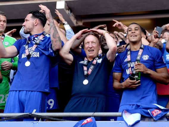 Cardiff City manager Neil Warnock celebrates promotion to the Premier League with his team. Pic: Press Association