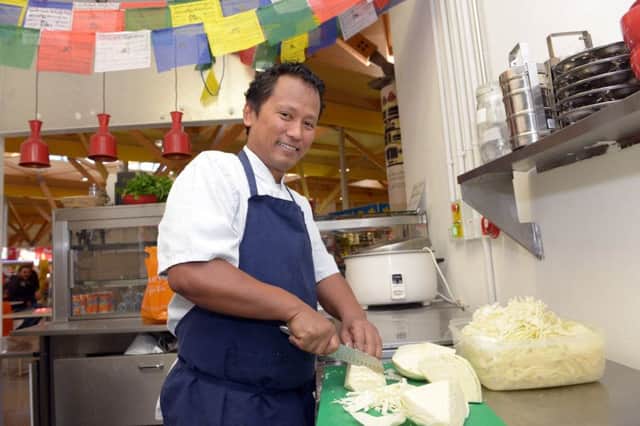 Hungry Buddha Dev prepares lunches at his Moor Market cafe