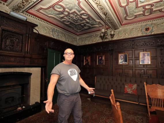Owner Sean Fogg surveys smoke damage to the Old Oak Room at Carbrook Hall