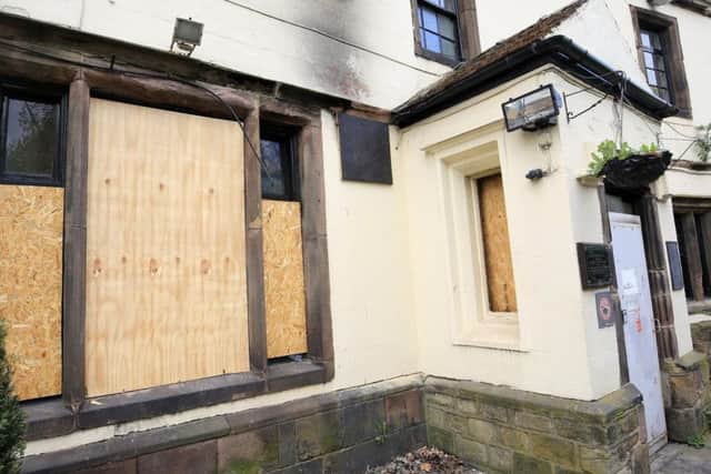Boarded-up windows at Carbrook Hall following the fire