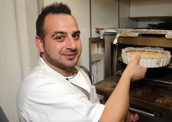 Head chef Antonio Buscemi at La Dolce Vita puts the chocolate and almond cake in the oven.