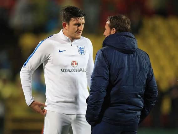 Harry Maguire speaking with England manager Gareth Southgate