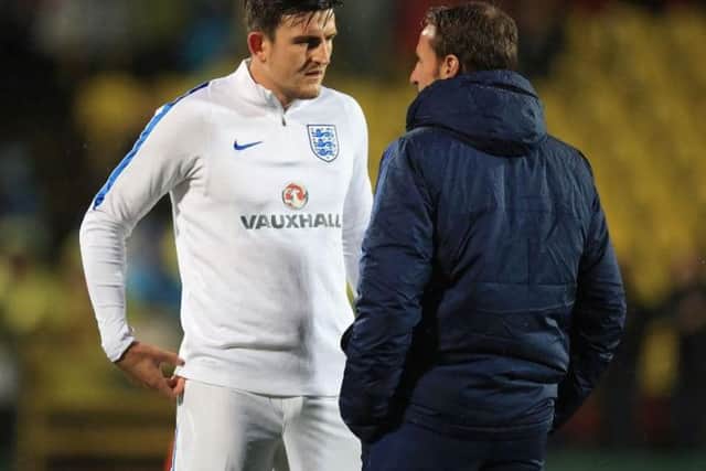 Harry Maguire talking to England boss Gareth Southgate