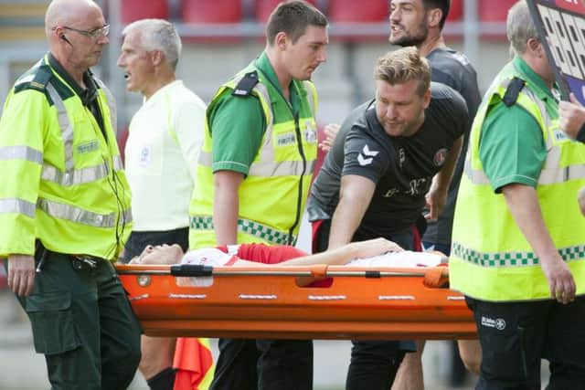 Jamie Proctor is stretchered off against Charlton Athletic in August