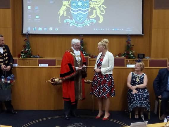 Civic duty: New Rotherham Mayor Alan Buckley presents his predecessor Coun Eve Keenan with a gift to recognise her work during a year in office.
