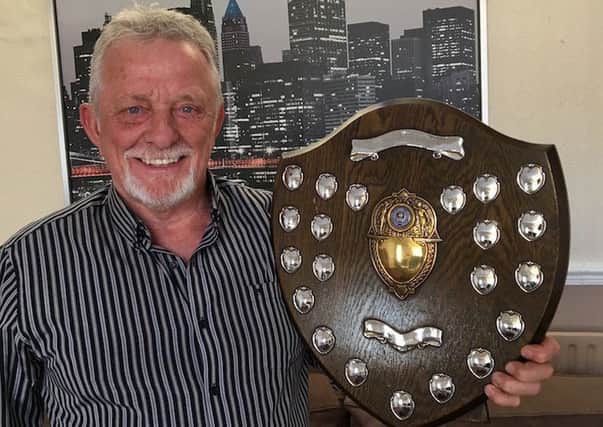 Roy Young, the former player/manager of Arbourthorne EA, with one of their trophies