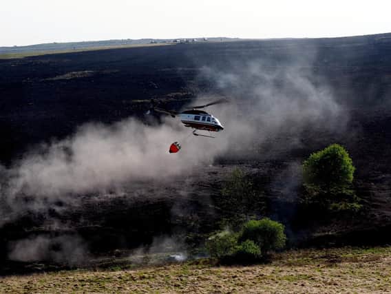 Helicopter dropping water to damp down the fire. Picture: David Bocking.