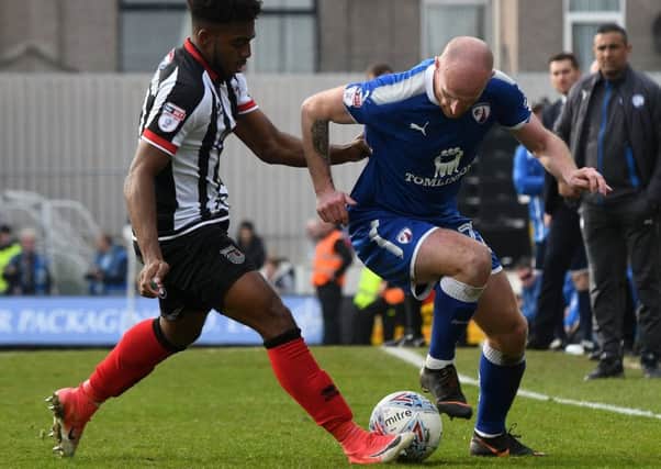 Picture Andrew Roe/AHPIX LTD, Football, EFL Sky Bet League Two, Grimsby Town v Chesterfield, Blundell Park, 07/04/18, K.O 3pmChesterfield's Drew Talbot is tackled by Grimsby's Reece Hall-JohnsonAndrew Roe>>>>>>>07826527594