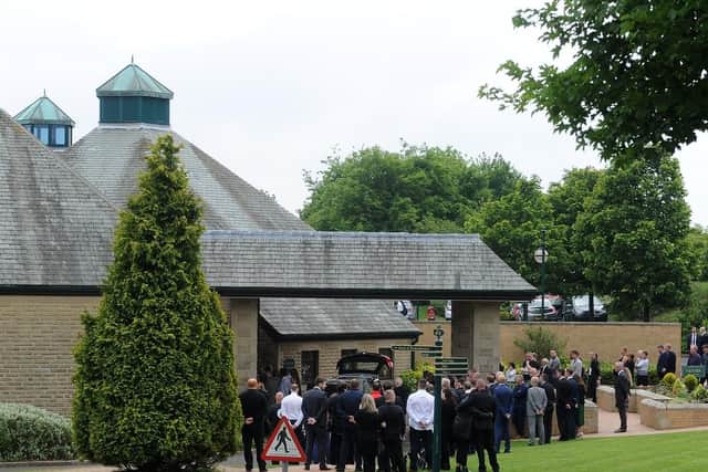 Mourners outside the North Chapel at Grenoside Crematorium.