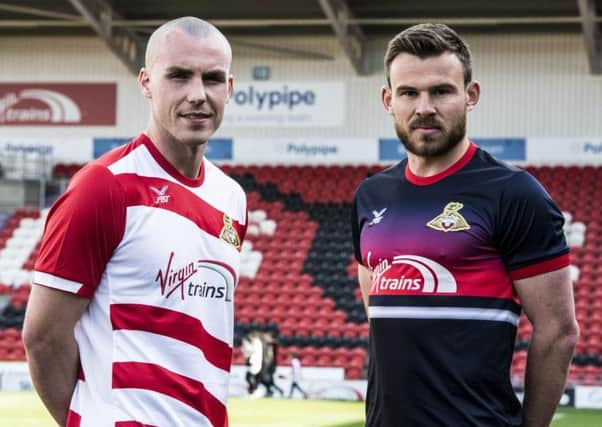 Luke McCullough and Andy Butler model next season's Doncaster Rovers kits