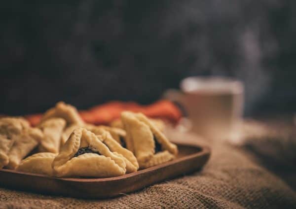 A traditional food served during Purim are hamantaschen, a triangular biscuit similar to a shortbread, typically filled with a sweet centre (Photo: Shutterstock)
